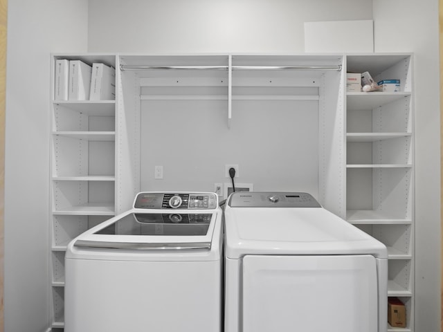 clothes washing area featuring washer and clothes dryer