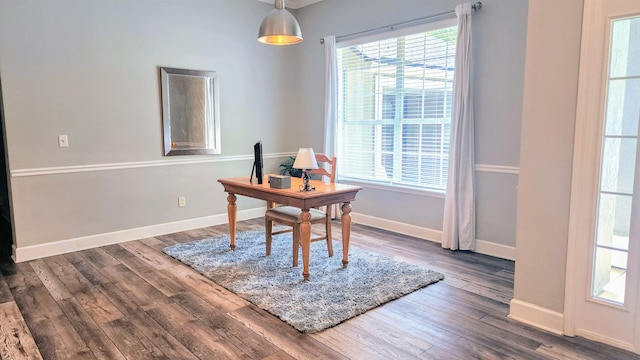 office space with wood finished floors and baseboards