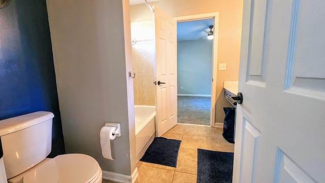 full bath with tile patterned flooring, toilet, baseboards, and shower / washtub combination