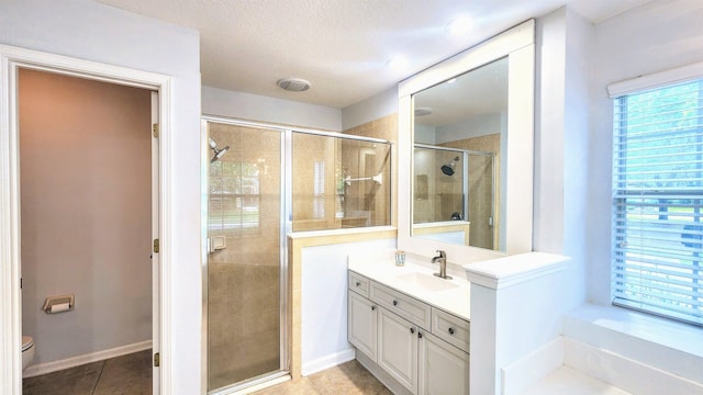 full bath with a shower stall, vanity, toilet, a textured ceiling, and tile patterned flooring