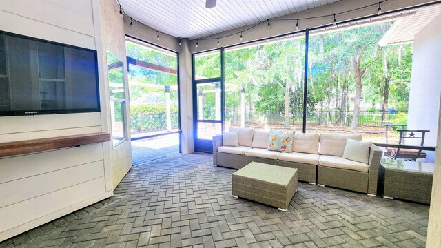 sunroom featuring an outdoor hangout area