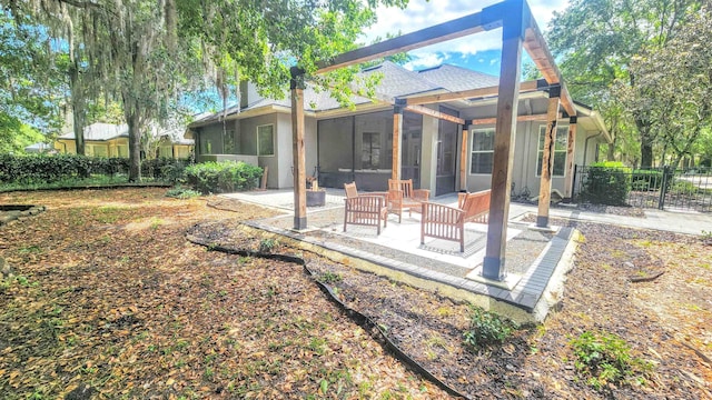 back of house featuring a patio, a sunroom, and fence