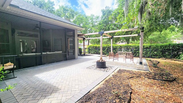 view of patio / terrace with a sunroom, fence, and a ceiling fan
