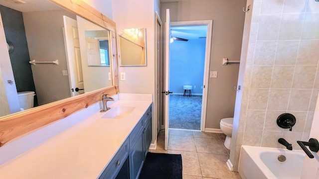 full bathroom with toilet, tile patterned floors, vanity, and washtub / shower combination