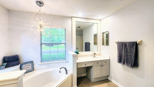 full bathroom with a chandelier, a bath, vanity, tile patterned flooring, and baseboards