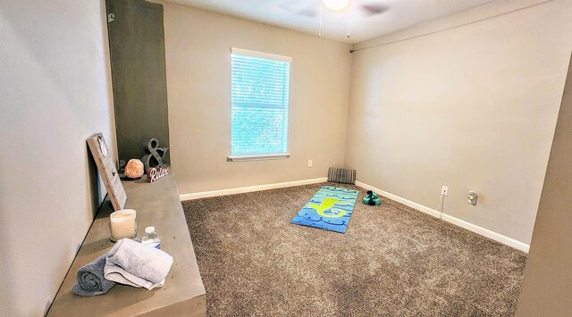 playroom featuring ceiling fan, carpet, and baseboards