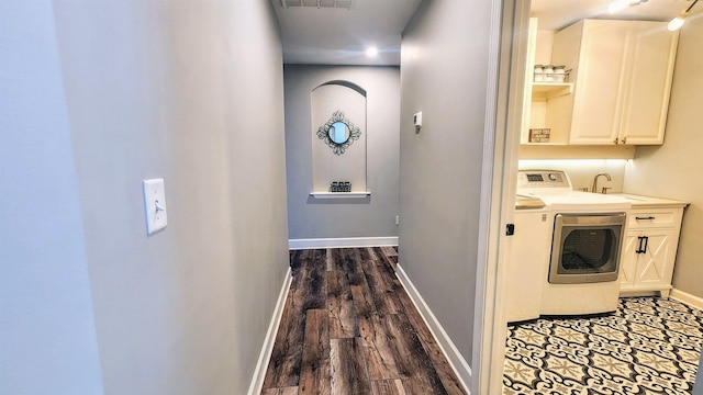 laundry area with washer / dryer, cabinet space, baseboards, and dark wood-style flooring
