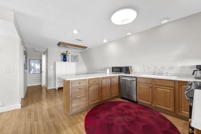 kitchen with stainless steel appliances, light wood-style floors, a peninsula, and visible vents