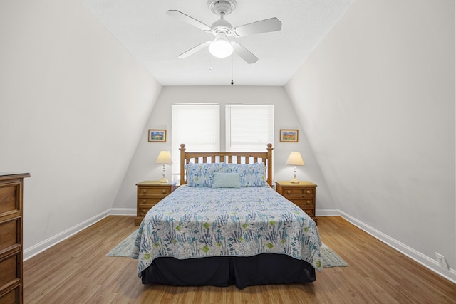 bedroom featuring wood finished floors, baseboards, and ceiling fan