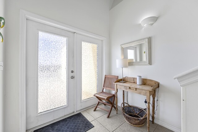 doorway featuring light tile patterned flooring, french doors, and baseboards