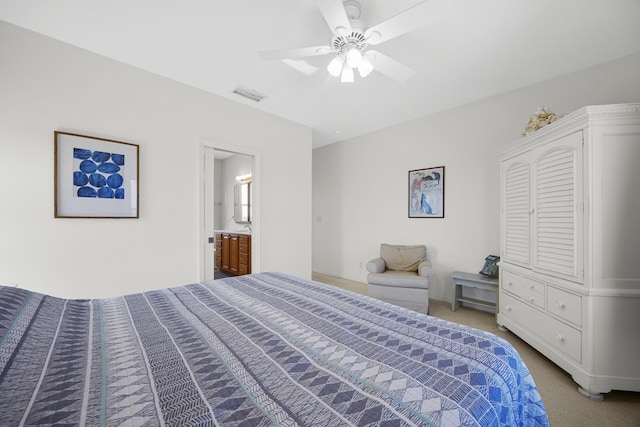 bedroom featuring light carpet, visible vents, ensuite bathroom, and ceiling fan