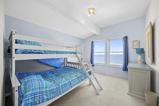 carpeted bedroom featuring vaulted ceiling with beams, baseboards, and a water view