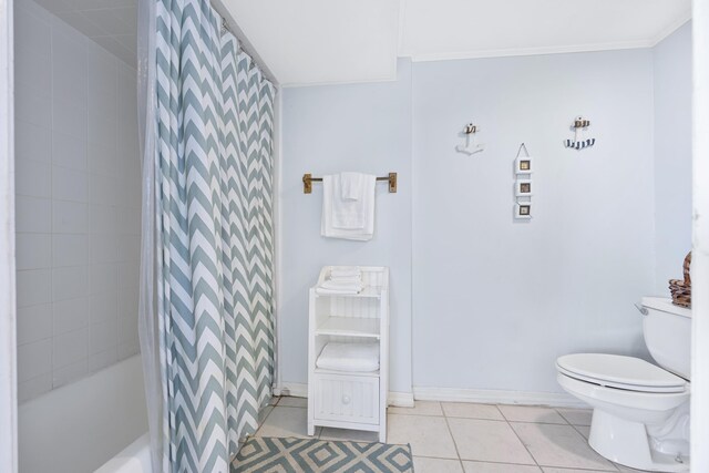 full bathroom featuring tile patterned flooring, toilet, baseboards, and ornamental molding