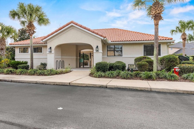 4515 Serena Cir, Saint Augustine, FL 32084 - mediterranean / spanish-style home with stucco siding, a tile roof, and a gate