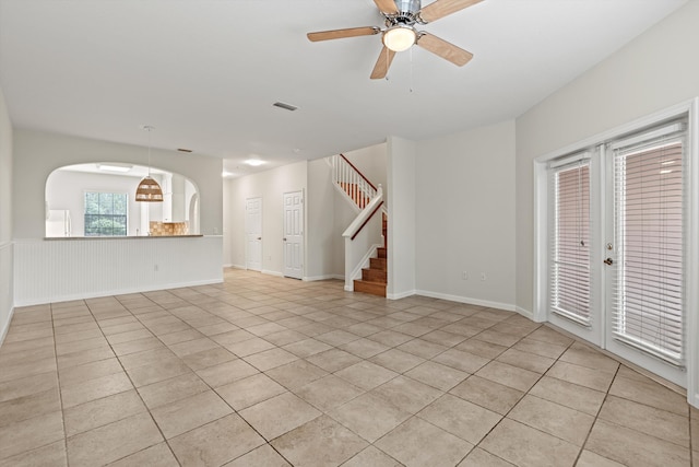4515 Serena Cir, Saint Augustine, FL 32084 - unfurnished living room with stairs, light tile patterned floors, a wainscoted wall, visible vents, and a ceiling fan