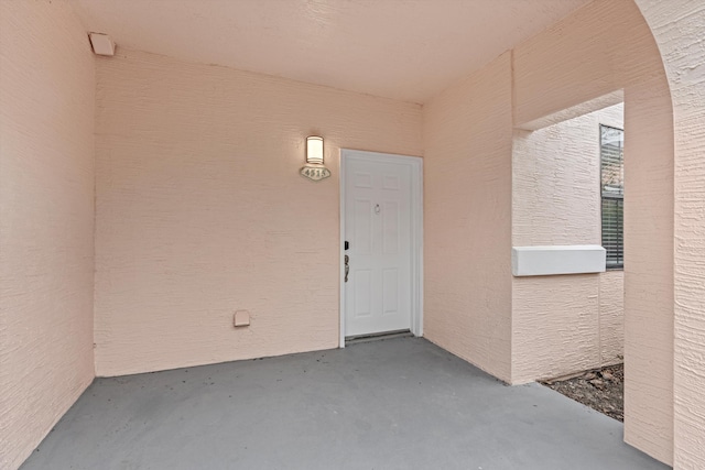 entrance to property featuring stucco siding