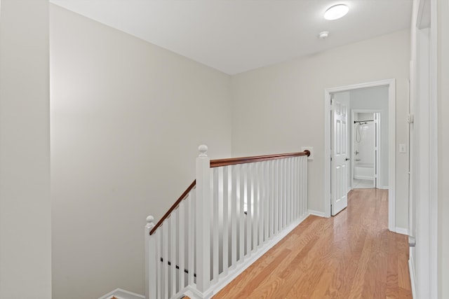 4515 Serena Cir, Saint Augustine, FL 32084 - hallway featuring light wood finished floors, baseboards, and an upstairs landing