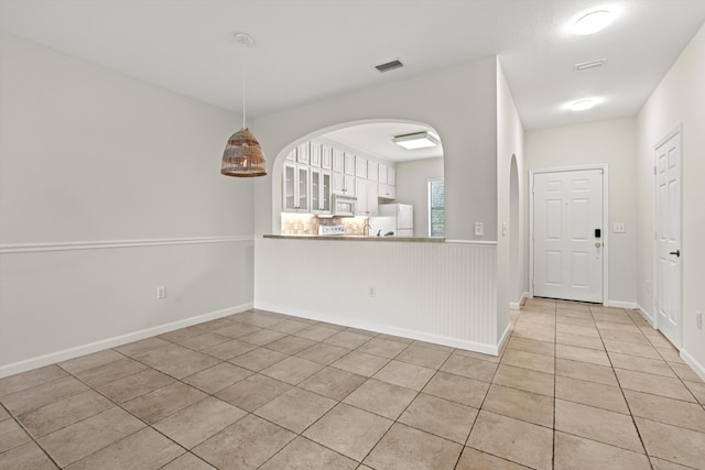 4515 Serena Cir, Saint Augustine, FL 32084 - interior space with light tile patterned flooring, baseboards, visible vents, and arched walkways