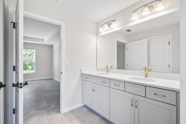 bathroom featuring tile patterned flooring and vanity