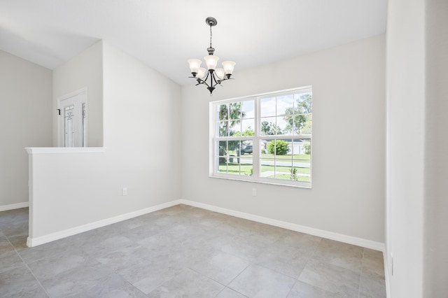 tiled empty room featuring a chandelier