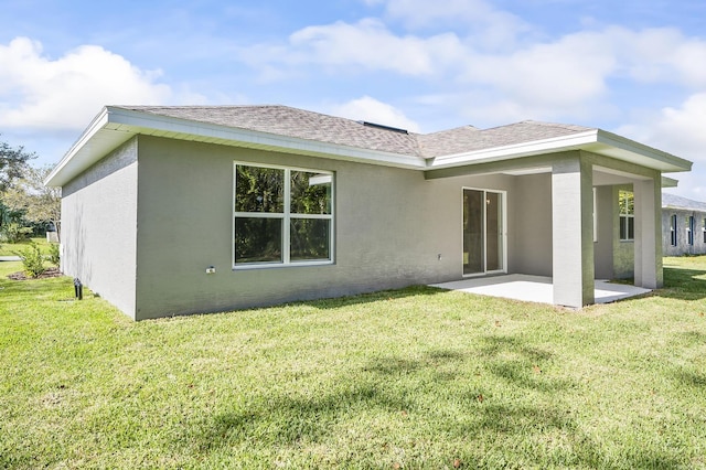 back of house with a patio area and a yard