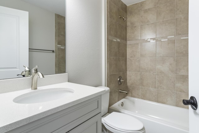 full bathroom featuring toilet, vanity, and tiled shower / bath