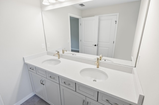 bathroom featuring tile patterned flooring and vanity