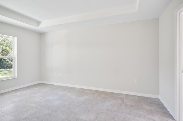 empty room featuring a raised ceiling