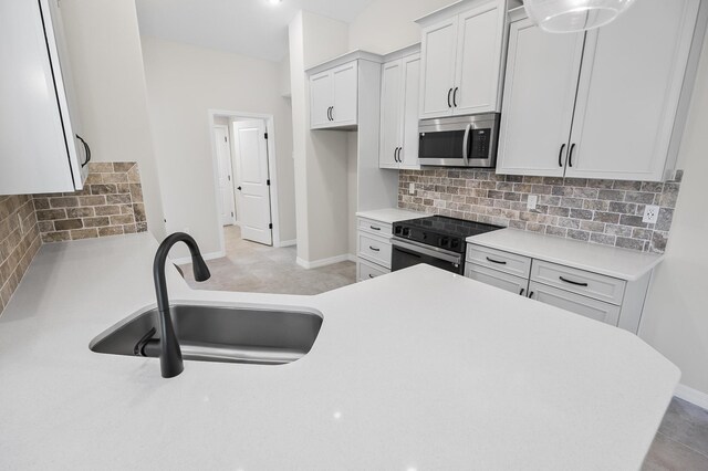 kitchen with backsplash, white cabinets, sink, and stainless steel appliances