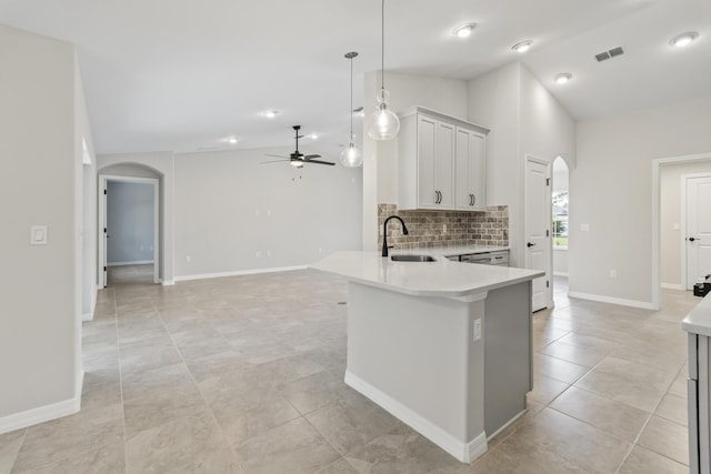 kitchen featuring pendant lighting, ceiling fan, lofted ceiling, and sink