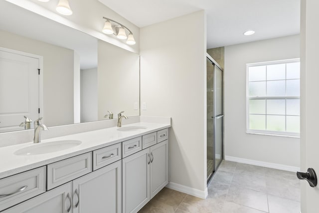 bathroom featuring tile patterned floors, vanity, and an enclosed shower