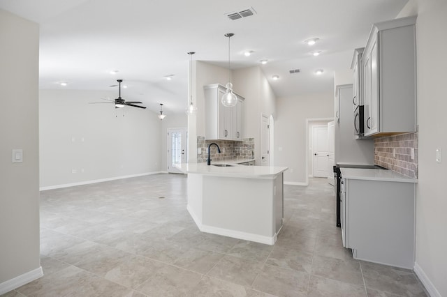 kitchen with ceiling fan, sink, stainless steel appliances, kitchen peninsula, and decorative light fixtures