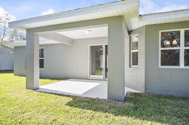 back of property with a patio area and a yard