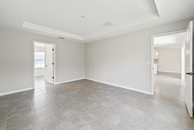 spare room featuring a tray ceiling