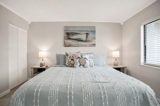 bedroom with crown molding, wood-type flooring, and a closet