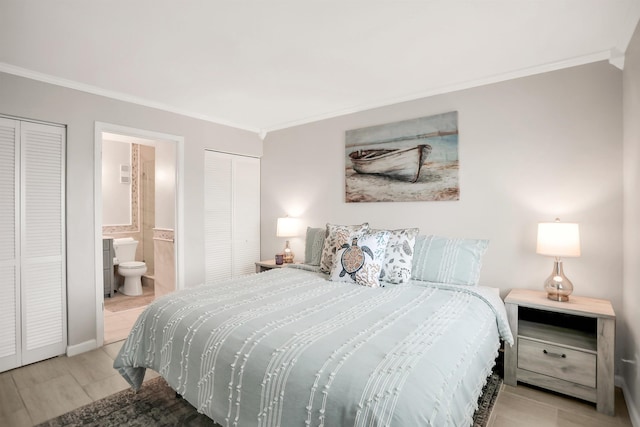 bedroom with ornamental molding and ensuite bathroom