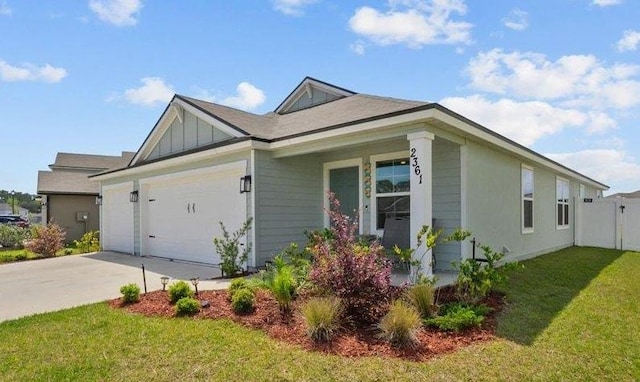 2361 Falling Star Ln, Green Cove Springs, FL 32043 - view of property exterior with a garage, fence, board and batten siding, a lawn, and driveway