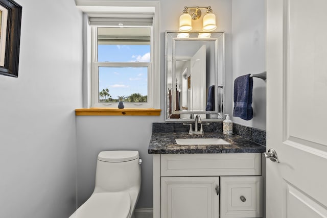 bathroom featuring vanity and toilet