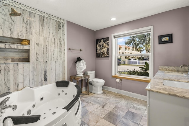 bathroom featuring a bath, vanity, and toilet