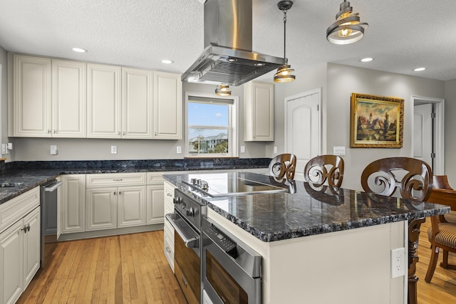 kitchen with pendant lighting, a textured ceiling, light hardwood / wood-style floors, white cabinetry, and island exhaust hood