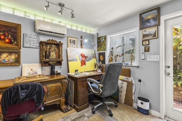 office space with a wall unit AC, light tile patterned flooring, and rail lighting