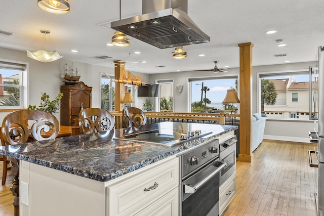 kitchen featuring a center island, light hardwood / wood-style flooring, oven, island range hood, and white cabinets