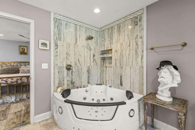 bathroom featuring a tub to relax in, tile patterned flooring, and a textured ceiling