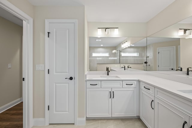 45 Laguna Forest Trl, Palm Coast, FL 32164 - full bath with a tile shower, double vanity, baseboards, and wood finished floors