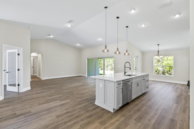 45 Laguna Forest Trl, Palm Coast, FL 32164 - kitchen featuring stainless steel dishwasher, a sink, lofted ceiling, arched walkways, and open floor plan