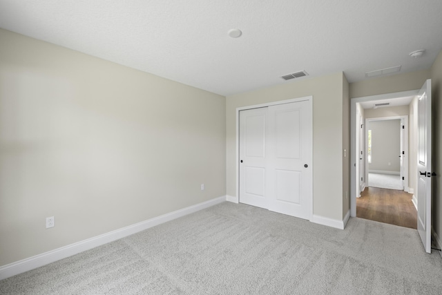 45 Laguna Forest Trl, Palm Coast, FL 32164 - unfurnished bedroom with carpet flooring, baseboards, and a closet