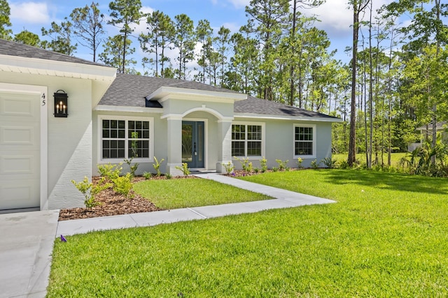 45 Laguna Forest Trl, Palm Coast, FL 32164 - view of front of home with a shingled roof, a front yard, and stucco siding