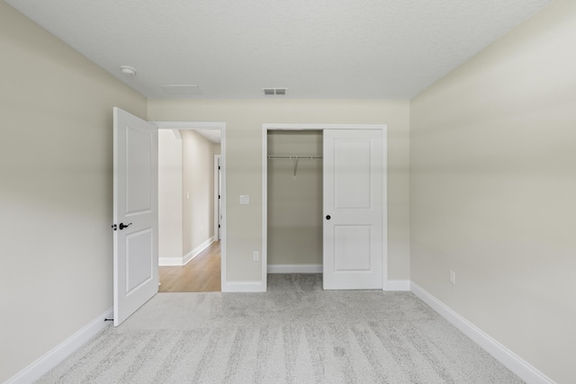 45 Laguna Forest Trl, Palm Coast, FL 32164 - unfurnished bedroom featuring carpet floors, baseboards, and a closet