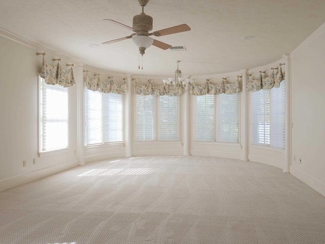 carpeted empty room with ceiling fan and ornamental molding