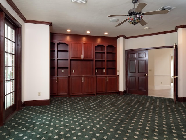 kitchen featuring dark colored carpet, ceiling fan, and crown molding